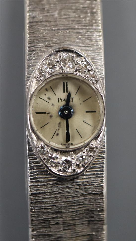 A ladys 750 white metal and diamond set Piaget manual wind bracelet wrist watch, approx. 17cm.